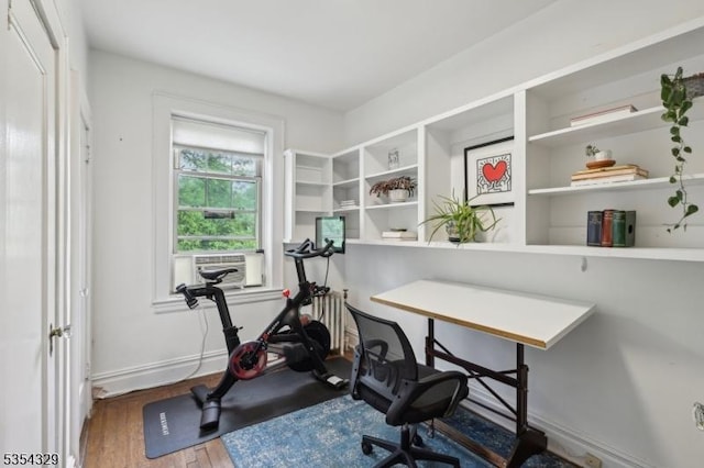 office with wood finished floors, cooling unit, and baseboards