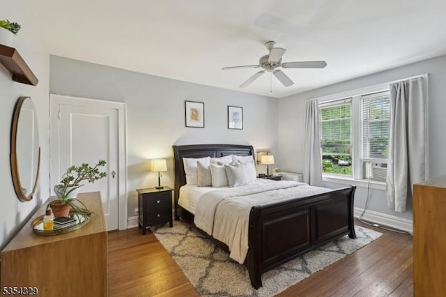 bedroom featuring hardwood / wood-style flooring, baseboards, and a ceiling fan