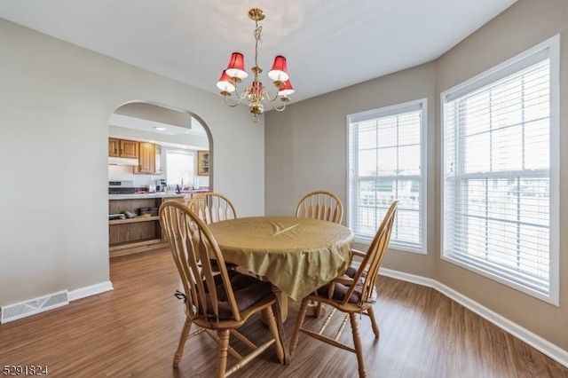 5 Bridgewater Ave, Stafford Twp, NJ 08050 - dining space featuring wood finished floors, baseboards, arched walkways, and plenty of natural light