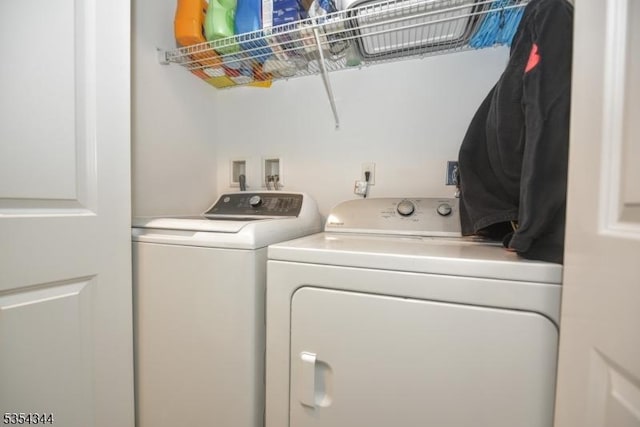 clothes washing area featuring laundry area and washing machine and clothes dryer