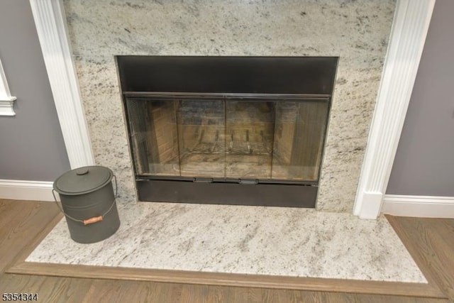 interior details with baseboards and wood finished floors
