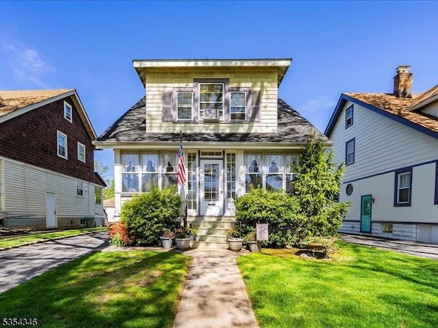 bungalow-style house with a front lawn