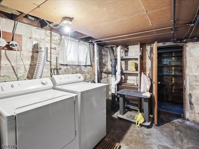 clothes washing area with laundry area and washer and clothes dryer