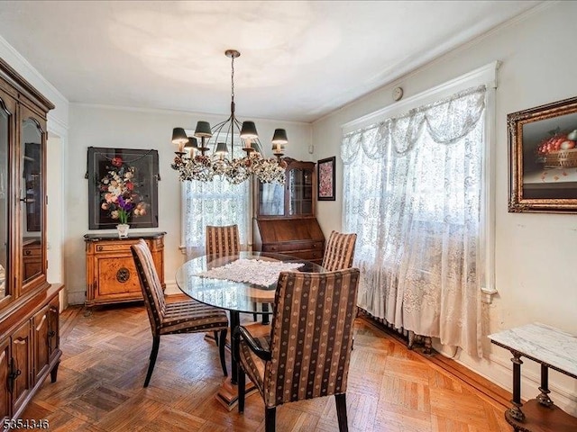 dining room featuring ornamental molding and a chandelier