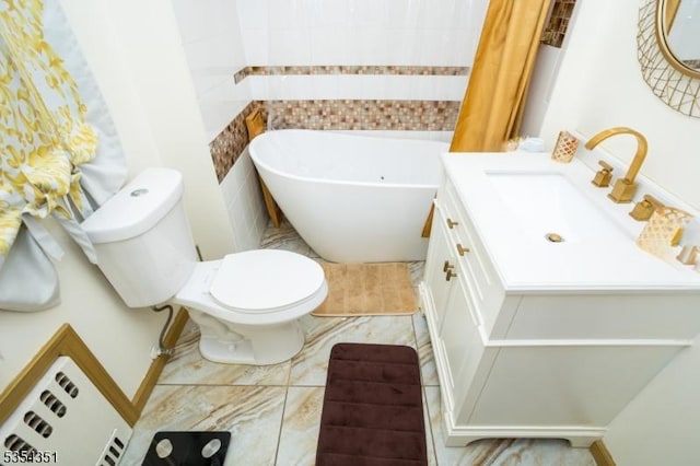 full bathroom with toilet, a tub to relax in, and vanity