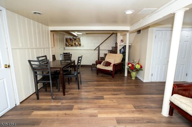 dining area featuring stairway, baseboards, wood finished floors, and visible vents