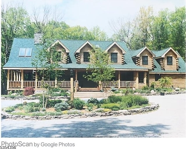 31 Kent Rd, Hampton Twp, NJ 07860 - view of front of property with covered porch, a chimney, and log siding