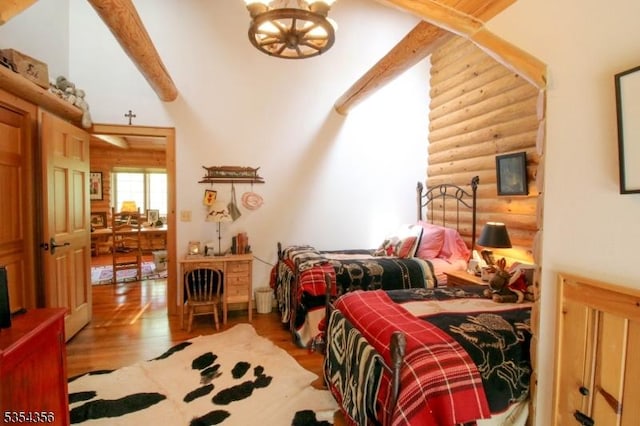 31 Kent Rd, Hampton Twp, NJ 07860 - bedroom featuring vaulted ceiling with beams, a chandelier, log walls, and wood finished floors
