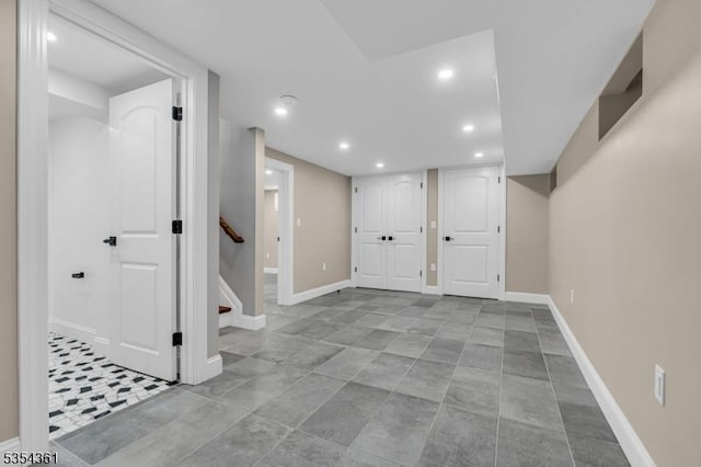 finished basement featuring stairway, baseboards, and recessed lighting