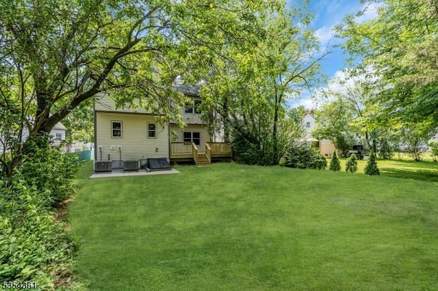 view of yard with a wooden deck and cooling unit