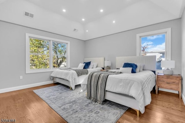 bedroom with recessed lighting, baseboards, visible vents, and wood finished floors