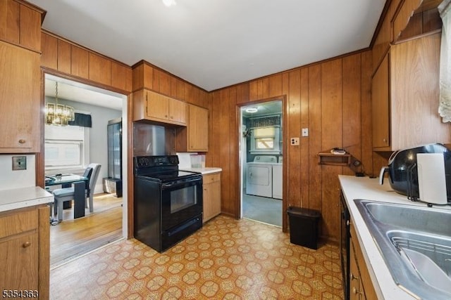 149 Roessler St, Boonton Town, NJ 07005 - kitchen featuring black electric range oven, washer and clothes dryer, a sink, light countertops, and light floors