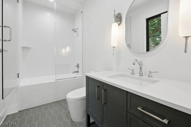 full bathroom featuring bath / shower combo with glass door, tile patterned flooring, vanity, and toilet