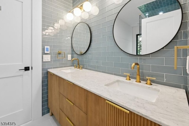 full bathroom with a sink, tile walls, decorative backsplash, and double vanity