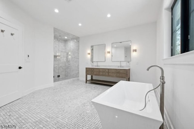 full bathroom with double vanity, recessed lighting, baseboards, a soaking tub, and a stall shower