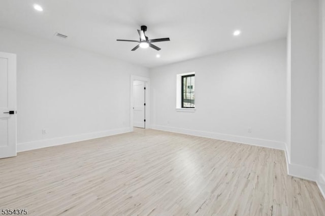 empty room featuring a ceiling fan, visible vents, baseboards, recessed lighting, and light wood-style flooring