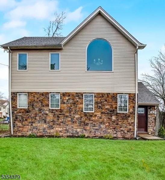 78 Henry St, Franklin Twp, NJ 08873 - back of house with a lawn, a shingled roof, and stone siding