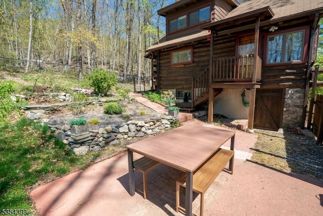 view of patio / terrace featuring a fenced backyard, stairway, and outdoor dining space