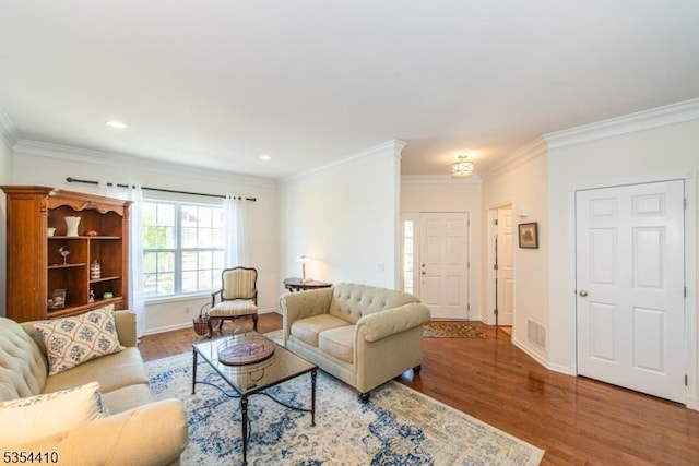 living room with recessed lighting, baseboards, wood finished floors, visible vents, and ornamental molding