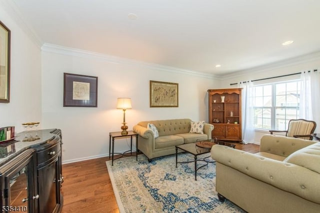 living area with crown molding, recessed lighting, baseboards, and wood finished floors