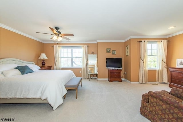 bedroom featuring crown molding, a ceiling fan, baseboards, and light colored carpet