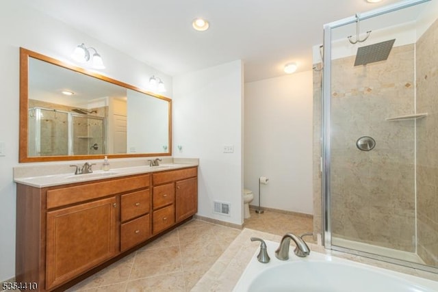 bathroom featuring double vanity, a sink, tile patterned floors, and a shower stall