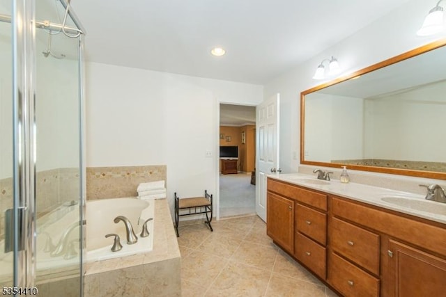 full bathroom featuring double vanity, a sink, a bath, and tile patterned flooring