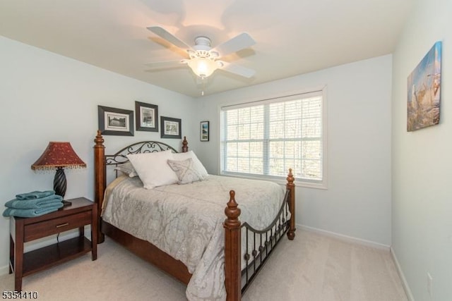 bedroom with baseboards, ceiling fan, and light carpet