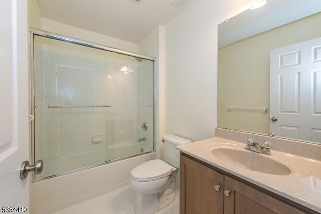 full bathroom with tile patterned flooring, vanity, toilet, visible vents, and bath / shower combo with glass door