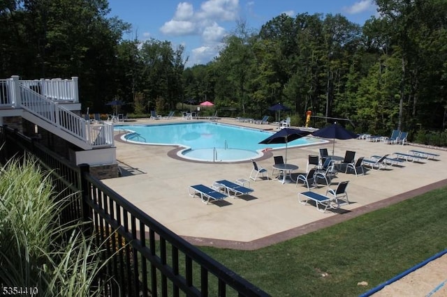 community pool featuring a patio and stairs