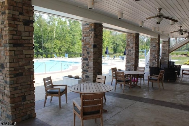 view of patio featuring ceiling fan and a community pool