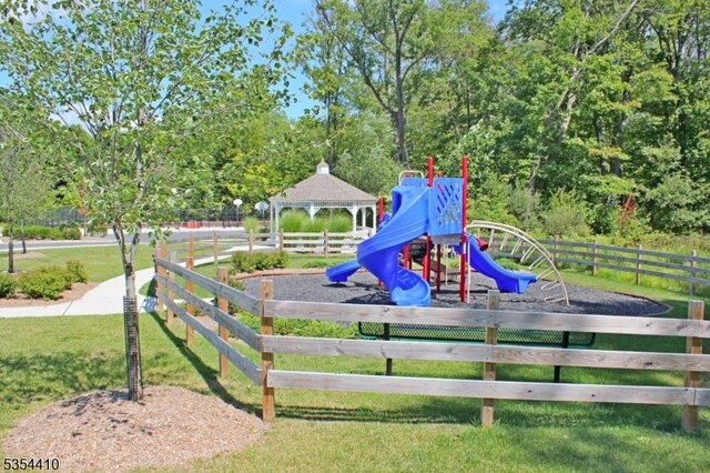 communal playground with a lawn and fence