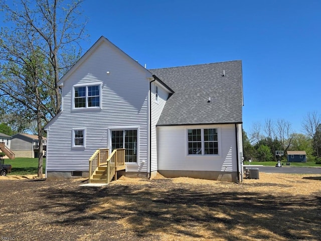 521 Parkwood Ct, Phillipsburg Town, NJ 08865 - rear view of property featuring central air condition unit and roof with shingles
