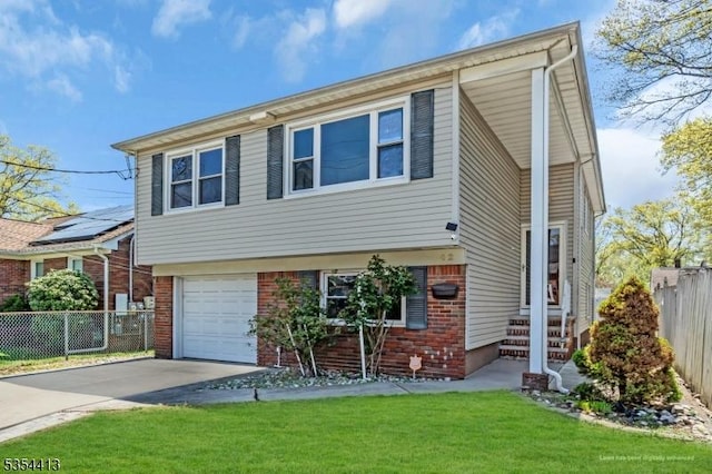 42 E Lincoln Ave, Roselle Park Boro, NJ 07204 - view of front of home with a garage, driveway, and brick siding