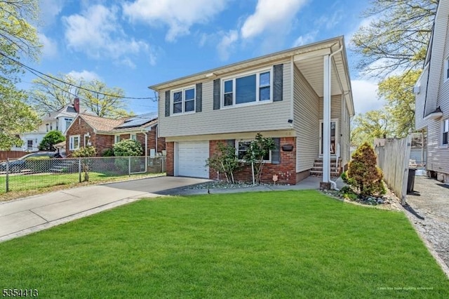 42 E Lincoln Ave, Roselle Park Boro, NJ 07204 - view of front facade with driveway, brick siding, and an attached garage