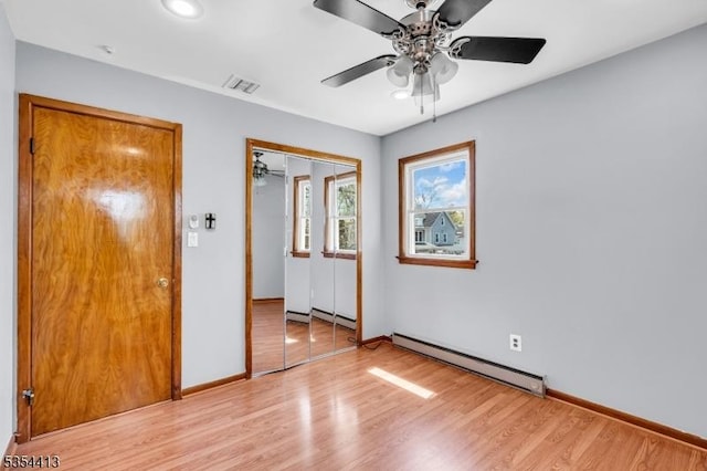 42 E Lincoln Ave, Roselle Park Boro, NJ 07204 - unfurnished bedroom with a baseboard heating unit, a closet, light wood-style floors, baseboards, and a baseboard radiator