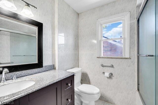 42 E Lincoln Ave, Roselle Park Boro, NJ 07204 - full bath featuring vanity, tile walls, toilet, and tile patterned floors