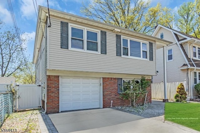 42 E Lincoln Ave, Roselle Park Boro, NJ 07204 - view of front of property with brick siding, an attached garage, and driveway