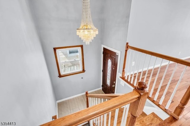 42 E Lincoln Ave, Roselle Park Boro, NJ 07204 - staircase with a towering ceiling, a chandelier, baseboards, and wood finished floors