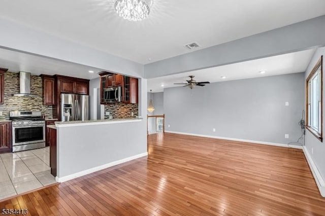 42 E Lincoln Ave, Roselle Park Boro, NJ 07204 - kitchen featuring stainless steel appliances, wall chimney range hood, backsplash, light countertops, and a ceiling fan