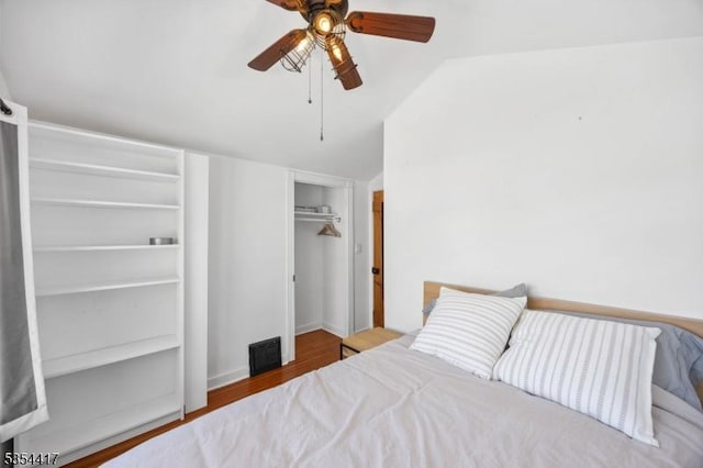 bedroom featuring visible vents, ceiling fan, wood finished floors, and lofted ceiling