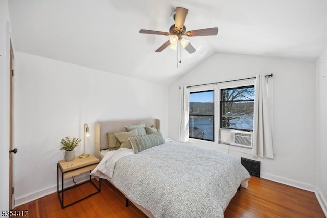 bedroom featuring baseboards, cooling unit, wood finished floors, and lofted ceiling