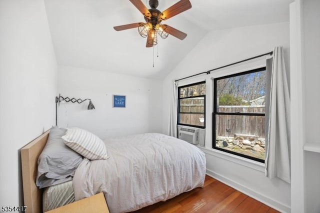 bedroom featuring ceiling fan, cooling unit, baseboards, wood finished floors, and lofted ceiling