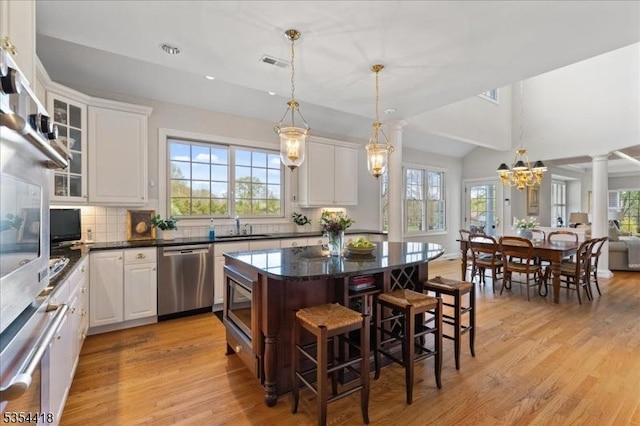 17 Hunters Path, Montgomery Twp, NJ 08558 - kitchen with visible vents, a center island, tasteful backsplash, a sink, and appliances with stainless steel finishes