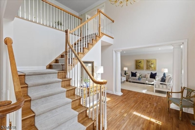 17 Hunters Path, Montgomery Twp, NJ 08558 - stairs with crown molding, wood finished floors, baseboards, a high ceiling, and ornate columns
