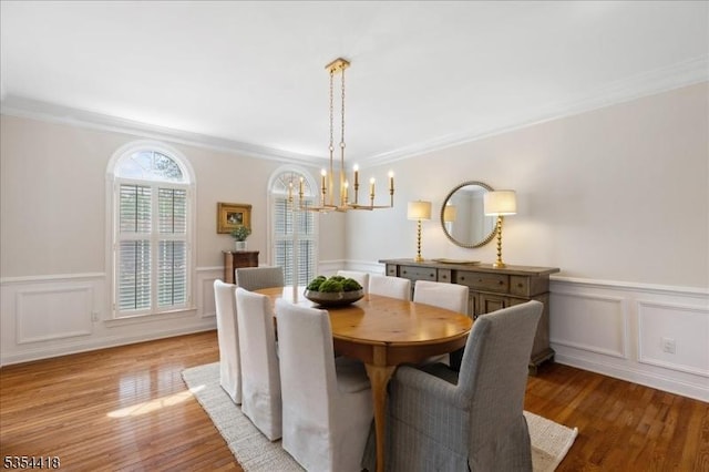 17 Hunters Path, Montgomery Twp, NJ 08558 - dining room featuring crown molding, an inviting chandelier, wood finished floors, and a wainscoted wall