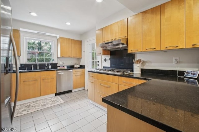 kitchen featuring appliances with stainless steel finishes, a sink, light tile patterned floors, under cabinet range hood, and recessed lighting