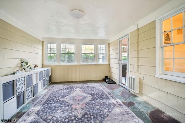unfurnished sunroom with visible vents