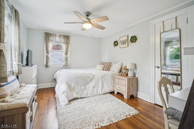 bedroom featuring baseboards, ceiling fan, and wood finished floors