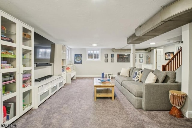 living area with carpet floors, baseboards, and stairway
